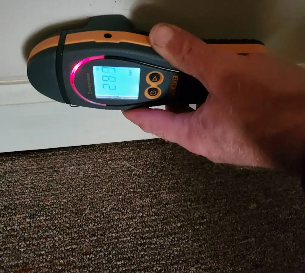 Moisture detection at baseboard during Storm Damage Restoration in Osage Beach